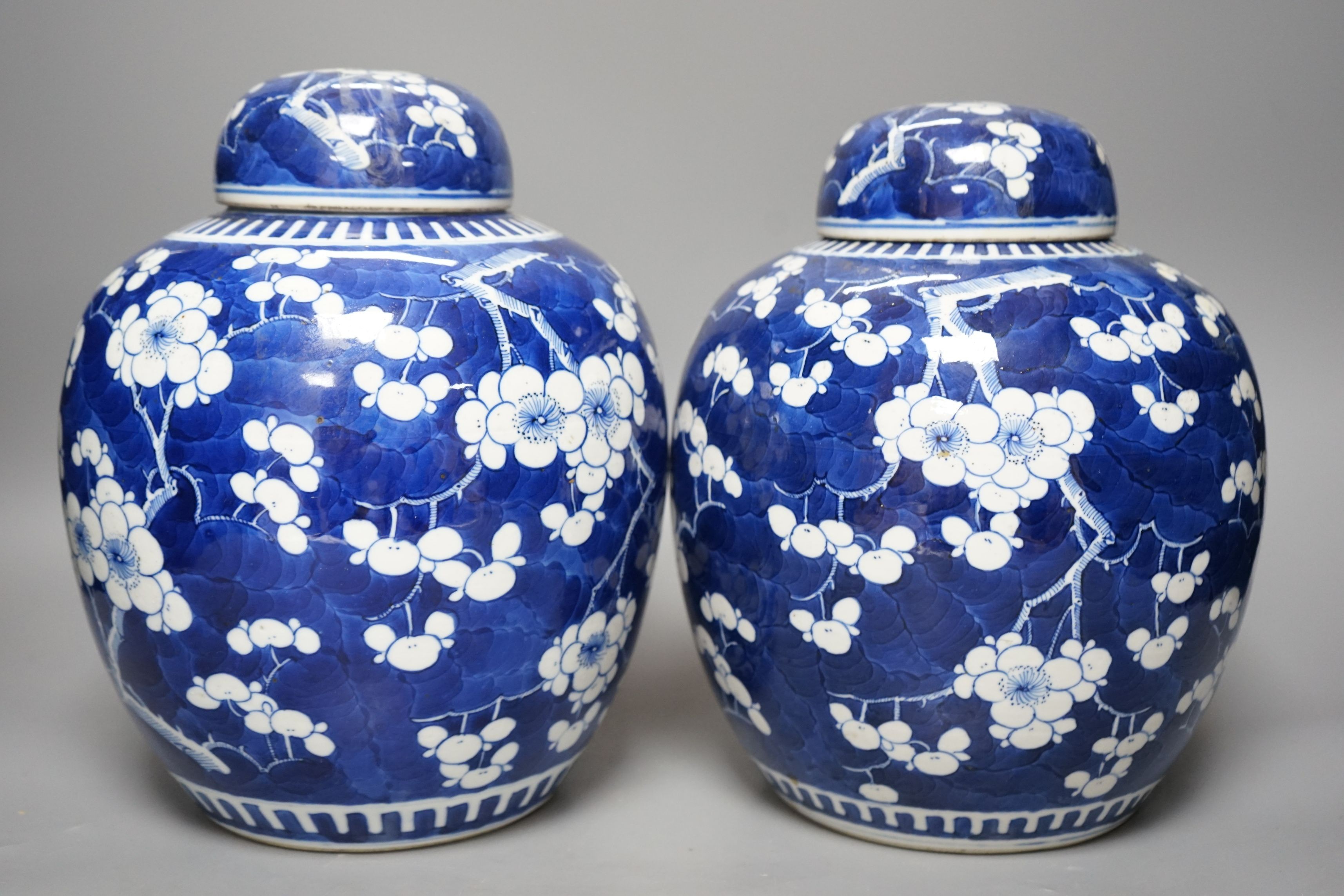 Two Chinese 20th century prunus jars and covers, 27cms high